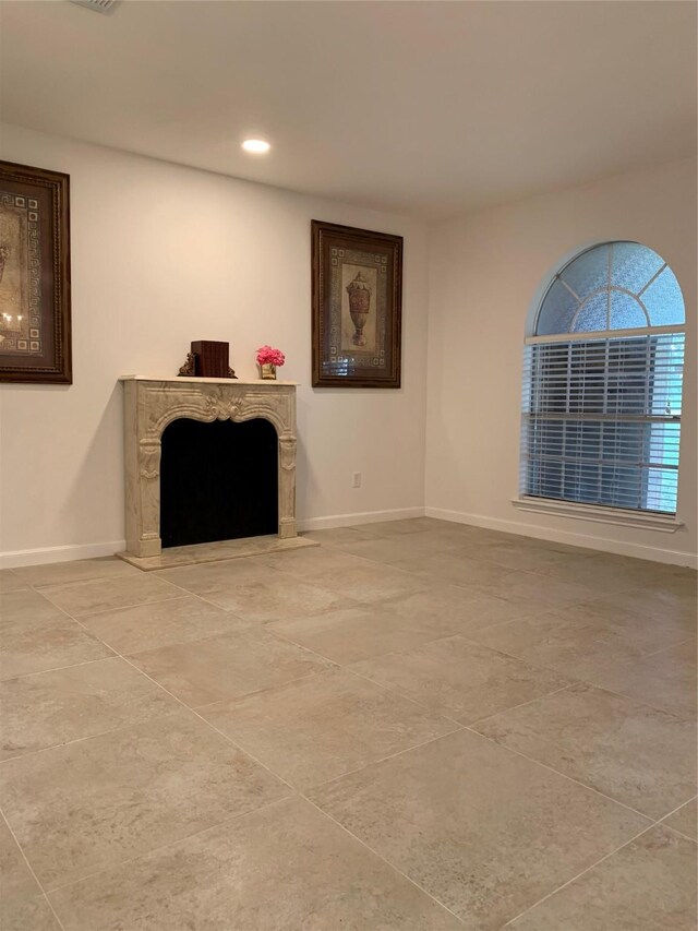 411 Sailfish St, Jones Creek, TX 77541 - unfurnished living room featuring a premium fireplace, recessed lighting, and tile patterned flooring