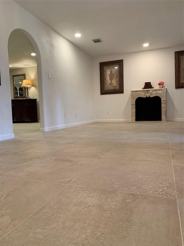 411 Sailfish St, Jones Creek, TX 77541 - unfurnished living room with arched walkways, recessed lighting, and a fireplace