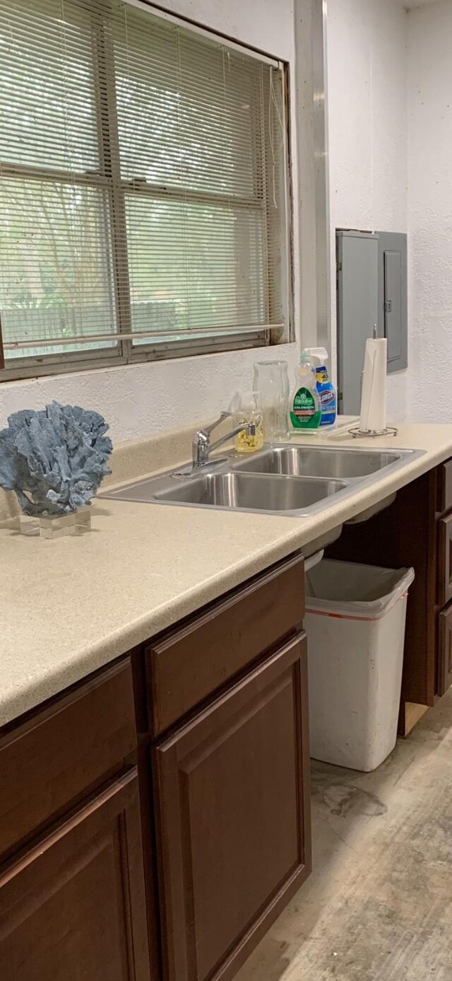 411 Sailfish St, Jones Creek, TX 77541 - kitchen featuring light countertops, dark brown cabinets, and electric panel