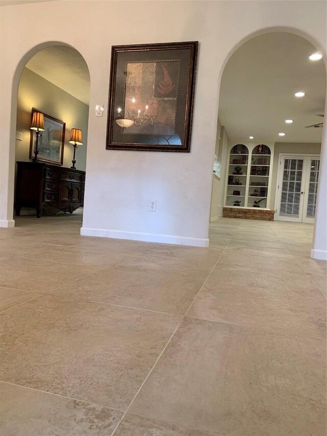 411 Sailfish St, Jones Creek, TX 77541 - tiled empty room with arched walkways, built in features, and recessed lighting