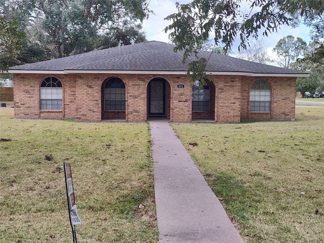 411 Sailfish St, Jones Creek, TX 77541 - ranch-style home with a front lawn, roof with shingles, and brick siding