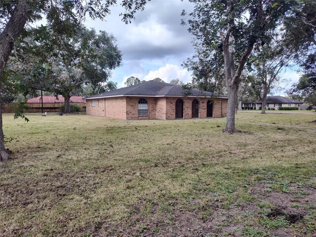 411 Sailfish St, Jones Creek, TX 77541 - view of side of home with brick siding