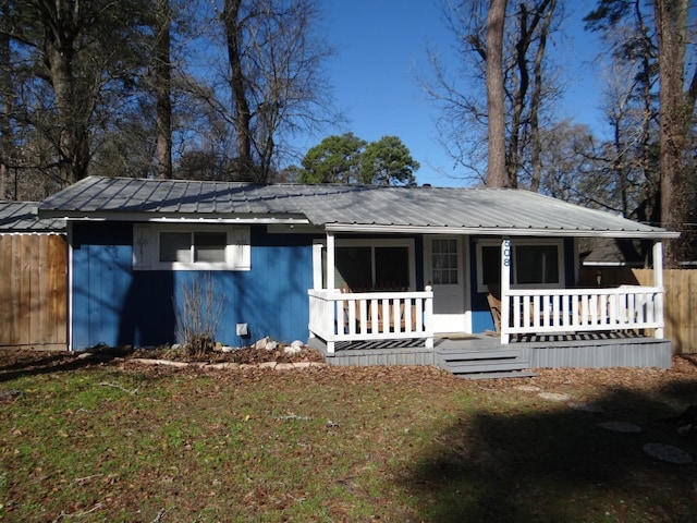 ranch-style home with a porch and a front yard