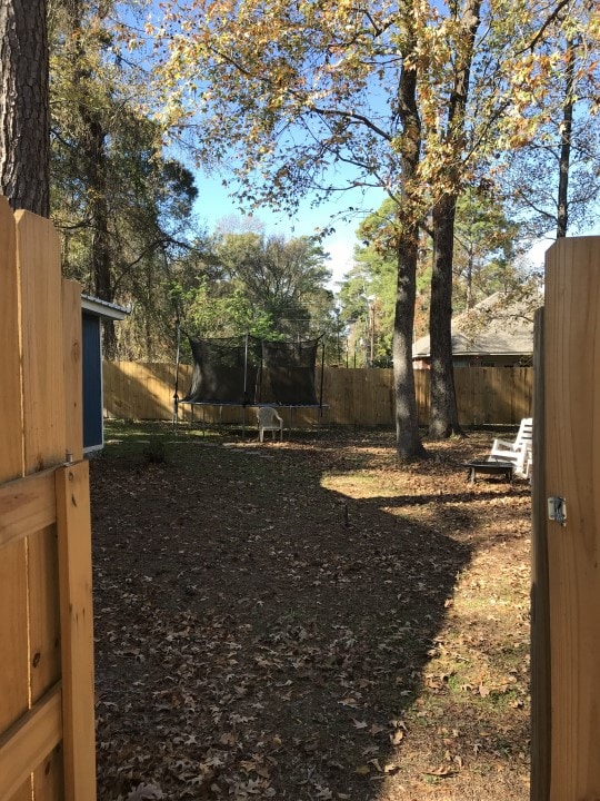 view of yard with a trampoline