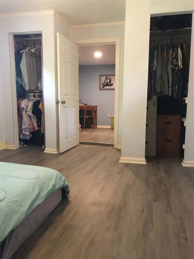 bedroom with crown molding and hardwood / wood-style flooring