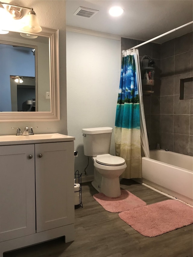 full bathroom featuring shower / bath combination with curtain, vanity, hardwood / wood-style floors, and toilet