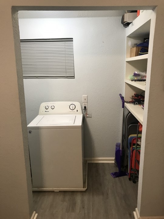 laundry room featuring dark hardwood / wood-style flooring and washer / dryer