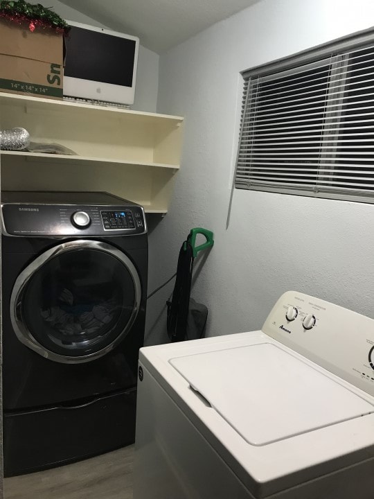 laundry room featuring hardwood / wood-style flooring and independent washer and dryer