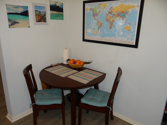 dining space with hardwood / wood-style floors