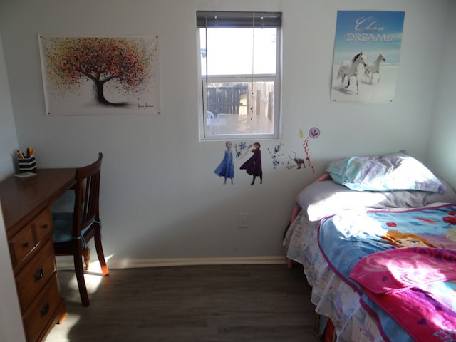 bedroom with dark hardwood / wood-style floors