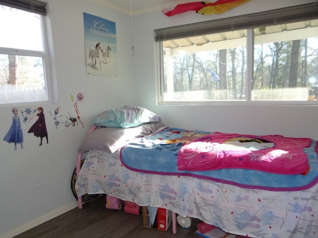 bedroom with dark hardwood / wood-style flooring