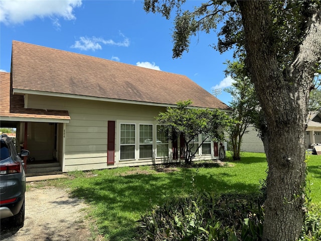 rear view of house with a yard