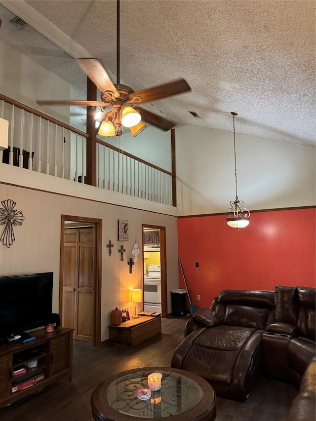 living room featuring hardwood / wood-style floors, a textured ceiling, high vaulted ceiling, and ceiling fan