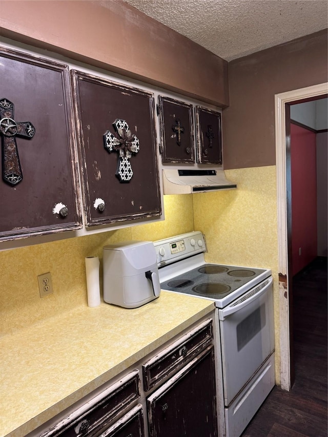 kitchen with a textured ceiling, dark brown cabinetry, white electric range, extractor fan, and dark wood-type flooring