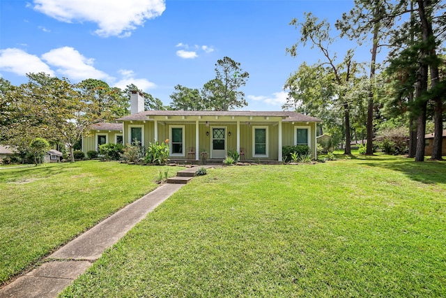 ranch-style home with a front yard and covered porch