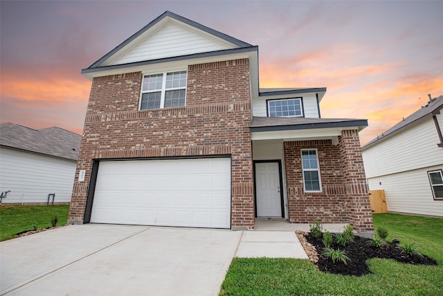 front facade featuring a garage and a lawn