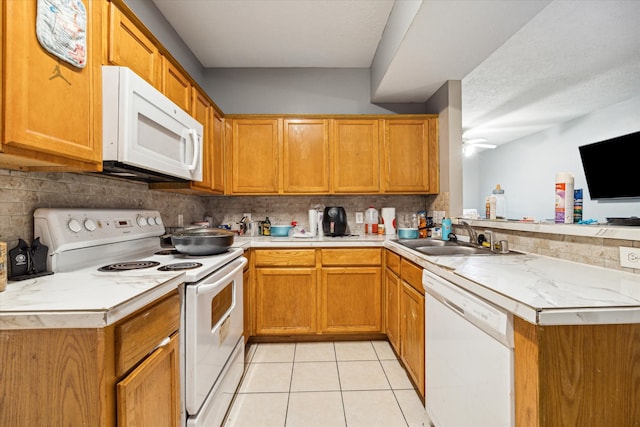 kitchen featuring light tile patterned floors, white appliances, sink, ceiling fan, and decorative backsplash