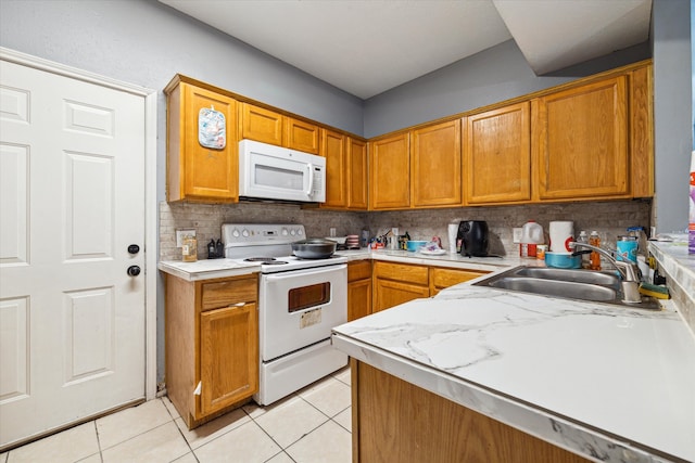 kitchen featuring tasteful backsplash, sink, white appliances, and light tile patterned flooring