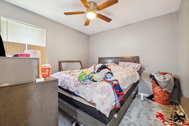 bedroom with ceiling fan and light carpet