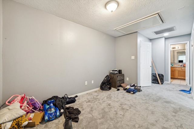 interior space with light carpet and a textured ceiling