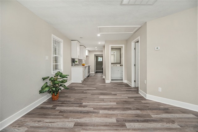 hall featuring a textured ceiling and hardwood / wood-style flooring