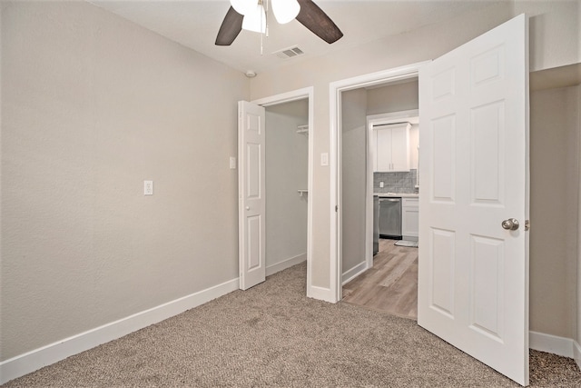 unfurnished bedroom featuring ceiling fan and light colored carpet