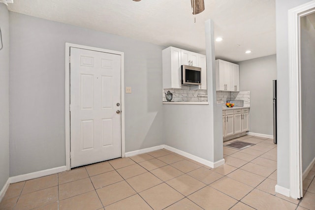 entryway featuring a textured ceiling and light tile patterned flooring