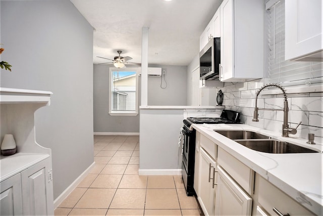 kitchen featuring white cabinetry, stainless steel appliances, sink, and ceiling fan