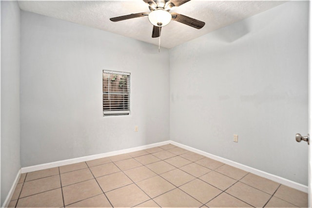 unfurnished room with a textured ceiling, ceiling fan, and light tile patterned floors