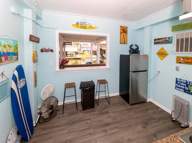 misc room with radiator and dark wood-type flooring