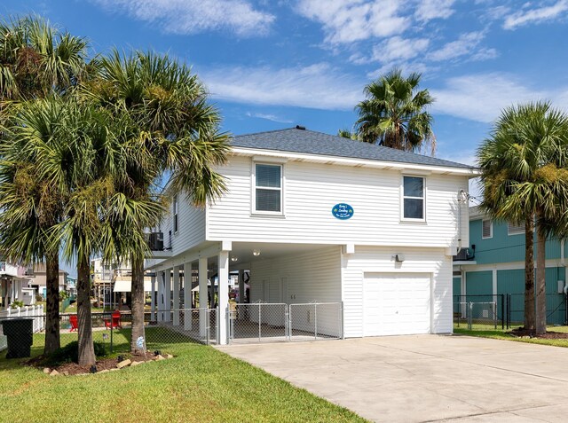 raised beach house featuring a carport, central air condition unit, and a garage