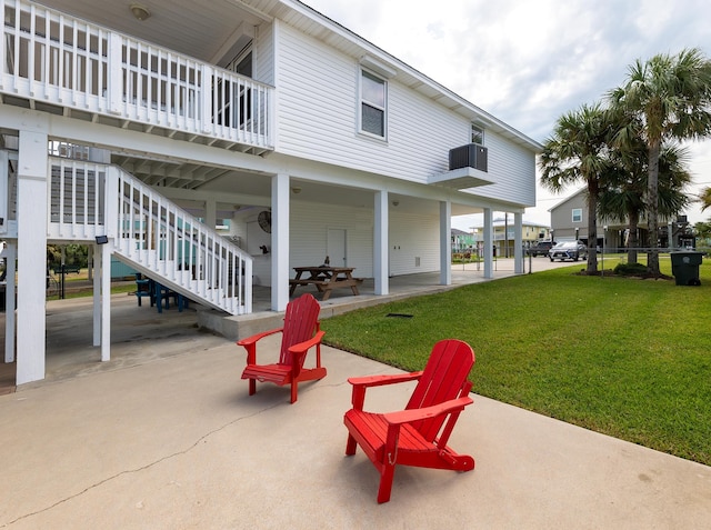 back of property featuring a patio and a lawn