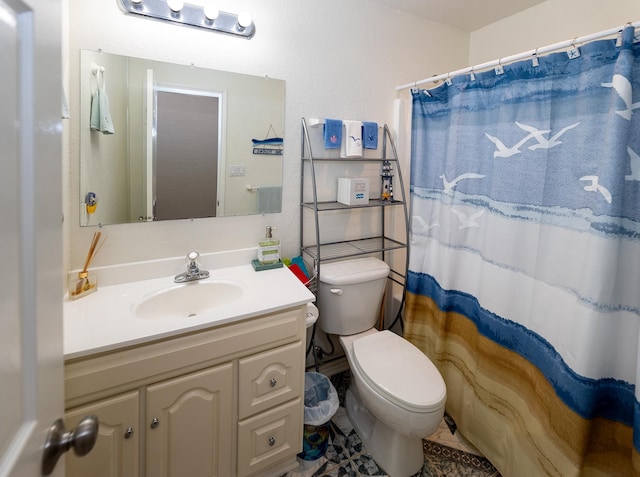 bathroom with tile patterned floors, toilet, and vanity