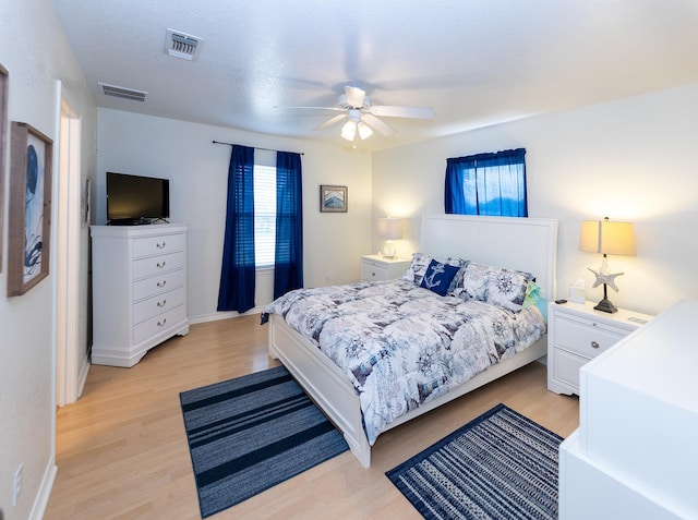 bedroom with ceiling fan and light hardwood / wood-style floors