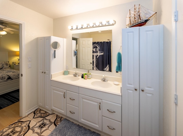 bathroom with dual vanity, ceiling fan, and hardwood / wood-style flooring