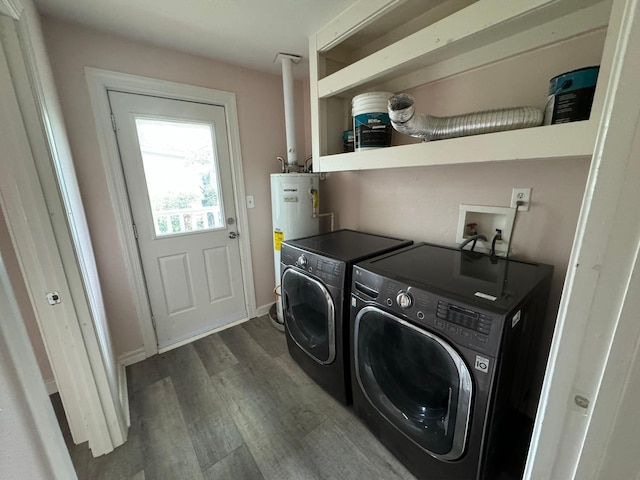 laundry room with washing machine and dryer, dark wood-type flooring, and water heater