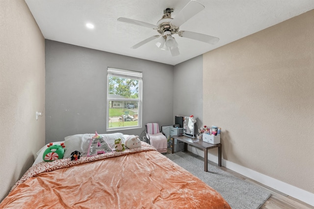 bedroom featuring light wood-type flooring and ceiling fan