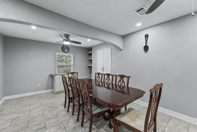 dining space with light tile patterned floors, a textured ceiling, and ceiling fan