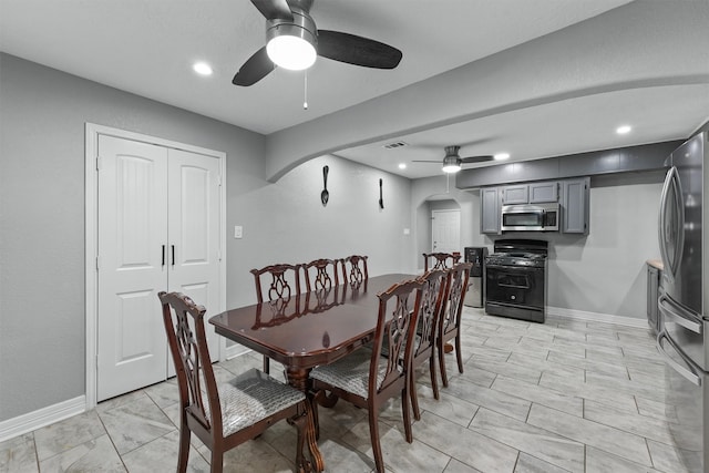 tiled dining room featuring ceiling fan