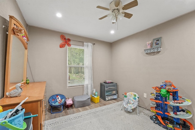 game room featuring wood-type flooring and ceiling fan