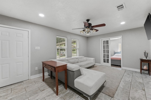 tiled living room with ceiling fan