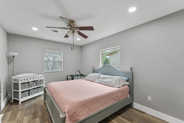 bedroom with dark hardwood / wood-style floors and ceiling fan