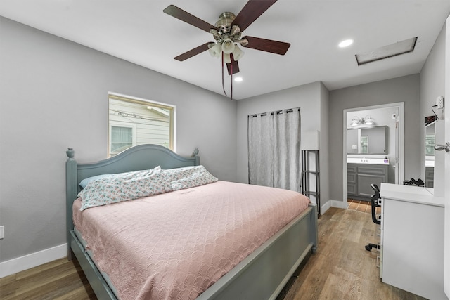 bedroom with ensuite bath, ceiling fan, and hardwood / wood-style floors