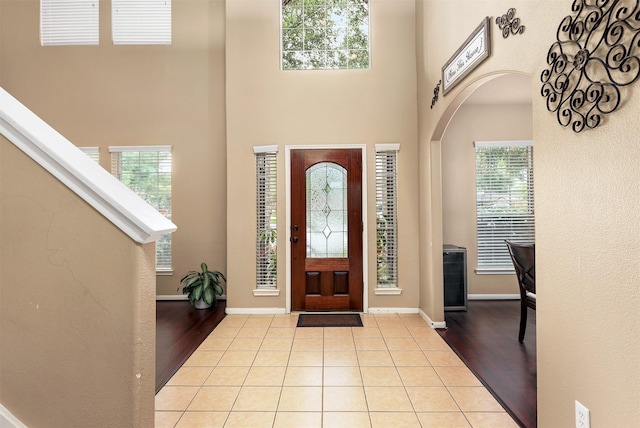 entrance foyer featuring a high ceiling and light tile patterned flooring