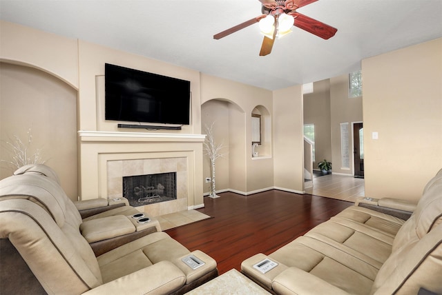 living room with hardwood / wood-style flooring, a fireplace, and ceiling fan