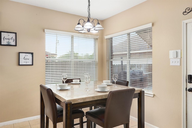 dining area featuring a chandelier and light tile patterned floors