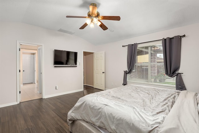 bedroom featuring ceiling fan, lofted ceiling, and dark hardwood / wood-style floors