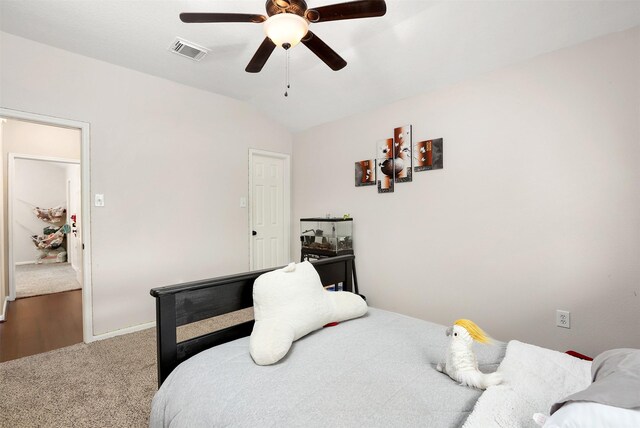 carpeted bedroom featuring vaulted ceiling and ceiling fan