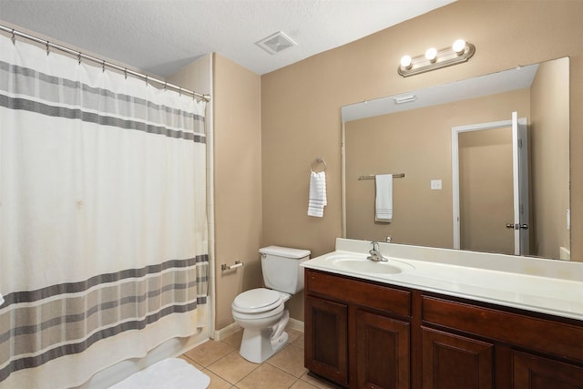 bathroom featuring vanity, toilet, tile patterned flooring, and a textured ceiling