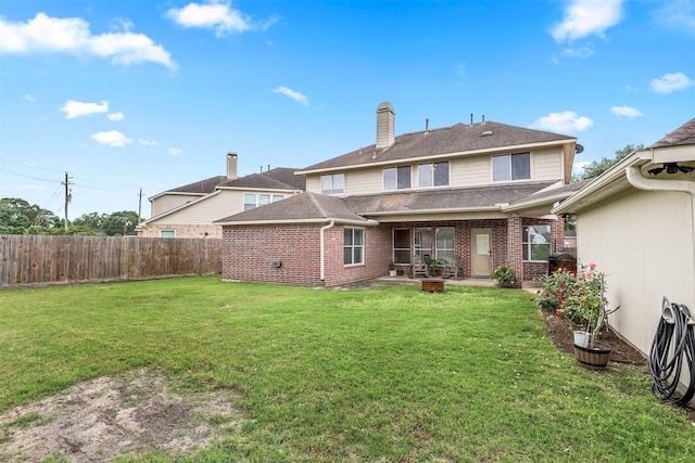 rear view of house with a yard